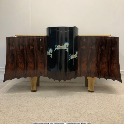 two-door credenza with in his center a swivel drum-shaped bar with carousel decor , made by Antoine Schapira in 2008 , graduated from École Boulle in Paris , materials used : rosewood, lacquer, gold leaf, parchment and leather , unique piece for sell